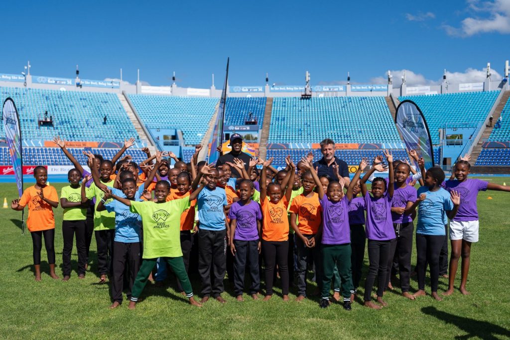 Letsile Tebogo and Sebastian Coe at the Kids' Athletics activation in Gaborone (© World Athletics photographer icon Christel Saneh)